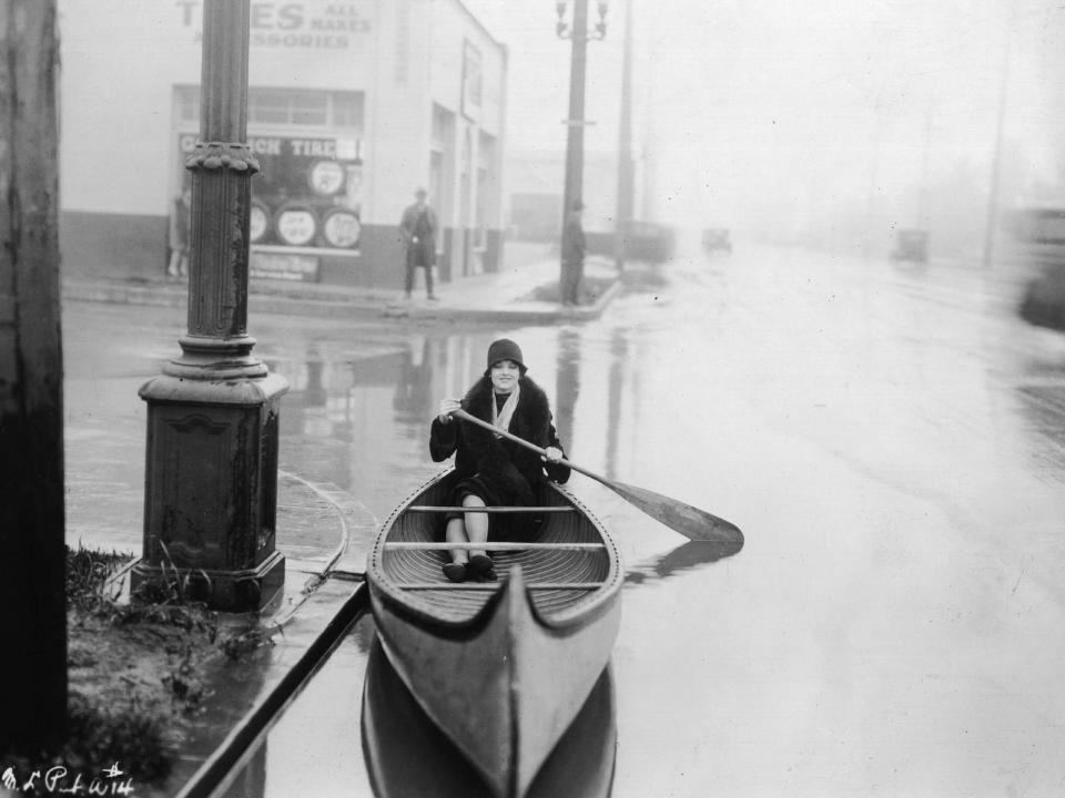 woman paddling in street