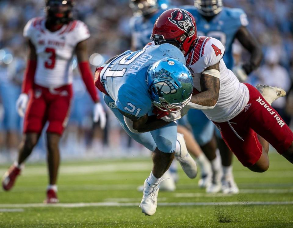 North Carolina’s Elijah Green (21) scores on a nine yard carry to cut the N.C. State lead to 14-10 in the second quarter on Friday, November 25, 2022 at Kenan Stadium in Chapel Hill, N.C.