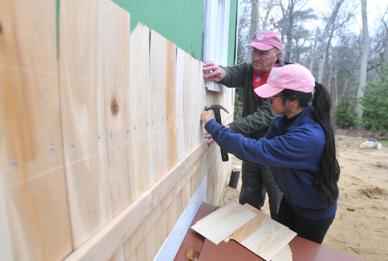 Habitat homeowner Bernalynn Sargent, right, works with volunteer Bob Lodi as they put shingles on her new home in Brewster. This Habitat for Humanity of Cape Cod home has three bedrooms and one and a half bathrooms. The home will be ready to be moved into in the fall. Two new Habitat for Humanity of Cape Cod homes are being built on Phoebe Way. The homes are constructed on property that Elizabeth Finch subdivided. Finch's home remains on the nearly 58,000-square-foot lot. To see more photos, go to www.capecodtimes.com.