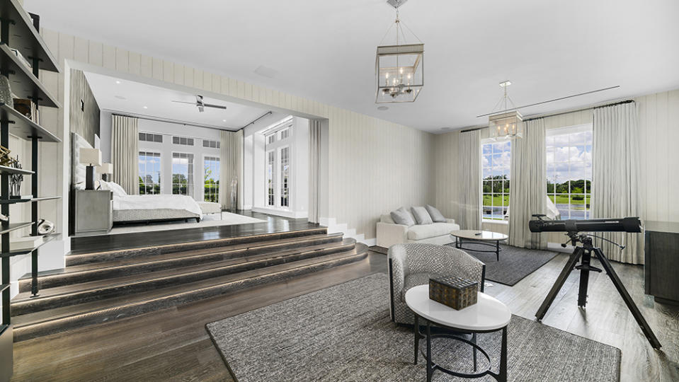 Inside the primary bedroom at 13001 with a tiered staircase and seating area - Credit: The Jills Zeder Group/1 Oak Studios