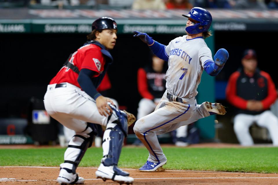 Kansas City Royals' Bobby Witt Jr. (7) scores past Cleveland Guardians catcher Bo Naylor on a sacrifice fly by Michael Massey during the sixth inning of a baseball game, Monday, Oct. 3, 2022, in Cleveland. (AP Photo/Ron Schwane)