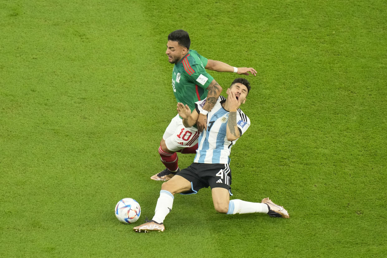 Mexico's Alexis Vega and Argentina's Gonzalo Montiel collide during the World Cup group C soccer match between Argentina and Mexico, at the Lusail Stadium in Lusail, Qatar, Saturday, Nov. 26, 2022. (AP Photo/Darko Bandic)