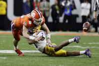 LSU safety Grant Delpit forces a fumble by Clemson quarterback Trevor Lawrence during the second half of a NCAA College Football Playoff national championship game Monday, Jan. 13, 2020, in New Orleans. (AP Photo/Sue Ogrocki)