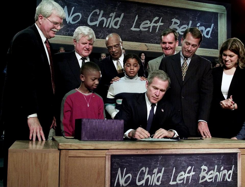 President George W. Bush signs into law the No Child Left Behind bill at Hamilton High School in Hamilton, Ohio in January 2002.