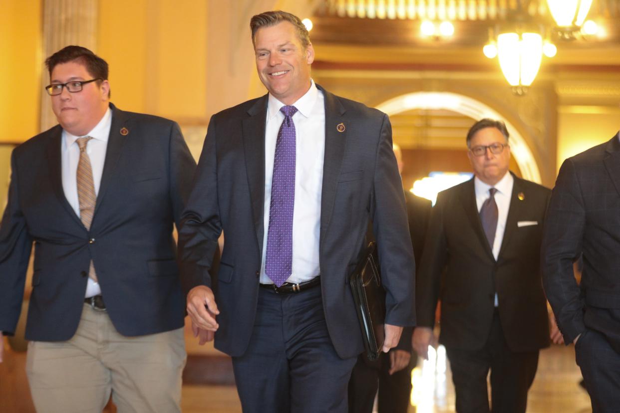 Kansas Attorney General Kris Kobach walks toward a news conference Thursday at the Kansas Statehouse where he announced a federal lawsuit against President Joe Biden over a student loan forgiveness program.