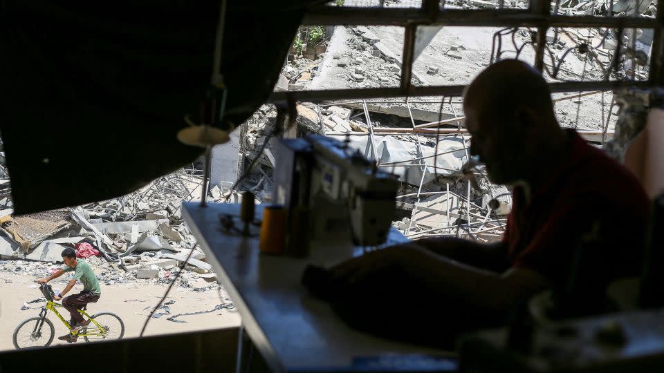 A Palestinian tailor works in a newly reopened sewing factory after the machines were retrieved from a building hit in an Israeli strike, amid Israel-Hamas conflict, in Khan Younis in the southern Gaza Strip on Wednesday. - Hatem Khaled/Reuters