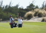 Justin Thomas, of the United States, right, checks the wind direction at the third fairway during the final round of the Hero World Challenge PGA Tour at the Albany Golf Club in New Providence, Bahamas, Sunday, Dec. 4, 2022. (AP Photo/Fernando Llano)