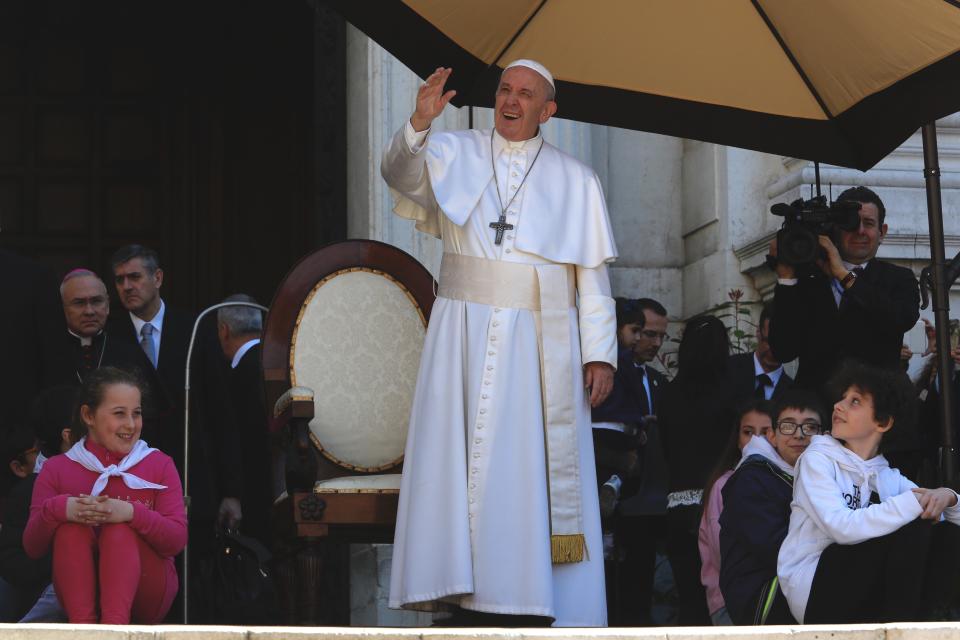 Pope Francis waves to the faithful gathered outside the Basilica of Our Lady of Loreto where, during a one-day visit, he celebrated mass and prayed in the shrine containing a small house traditionally venerated as the house of Mary, and believed miraculously transplanted from the Holy Land inside the Basilica, in central Italy, Monday, March 25, 2019. The pope chose Loreto to sign the Post-Synodal Exhortation of last October's Synod of Bishops. (AP Photo/Domenico Stinellis)