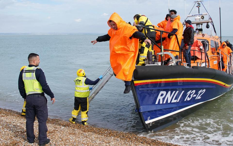 Migrants are brought into Dungeness beach after crossing the Channel - PA