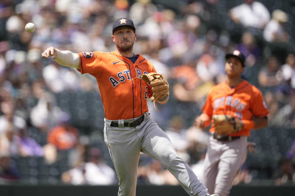 Houston Astros third baseman Alex Bregman throws to first base to put out Colorado Rockies' C.J. Cron in the second inning of a baseball game Wednesday, July 19, 2023, in Denver. (AP Photo/David Zalubowski)