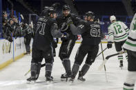 Tampa Bay Lightning's Anthony Cirelli (71) celebrates his goal with Victor Hedman, center, and Steven Stamkos, as Dallas Stars' Radek Faksa skates past during the second period of an NHL hockey game Saturday, Feb. 27, 2021, in Tampa, Fla. (AP Photo/Mike Carlson)