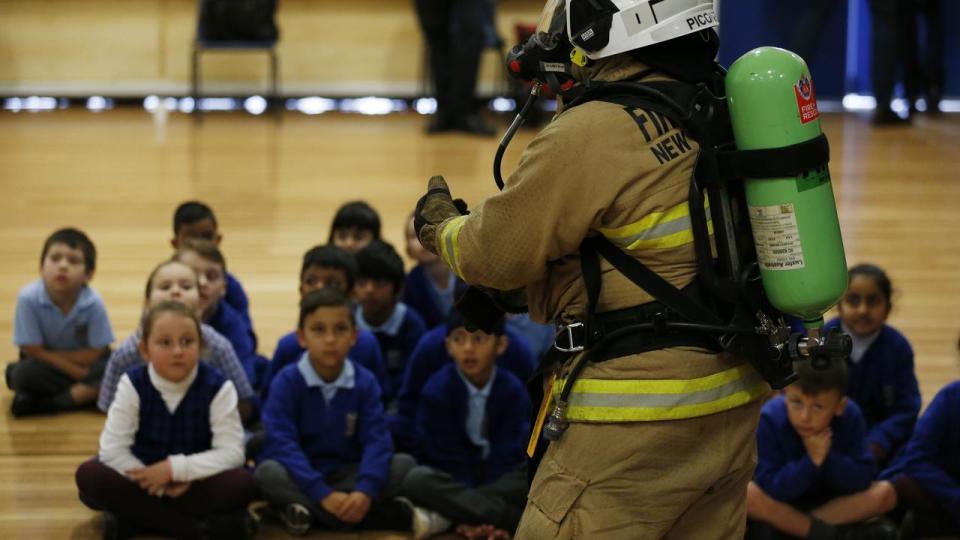 SYDNEY, AUSTRALIA - NewsWire Photos May 24, 2021: NSW RFS firefighters teach children to get down low and go, go, go at Bert Oldfield Public School in Seven Hills. Today is the launch of FRNSW's new education program aimed at teaching children about fire safety. Picture: NCA NewsWire / Nikki Short