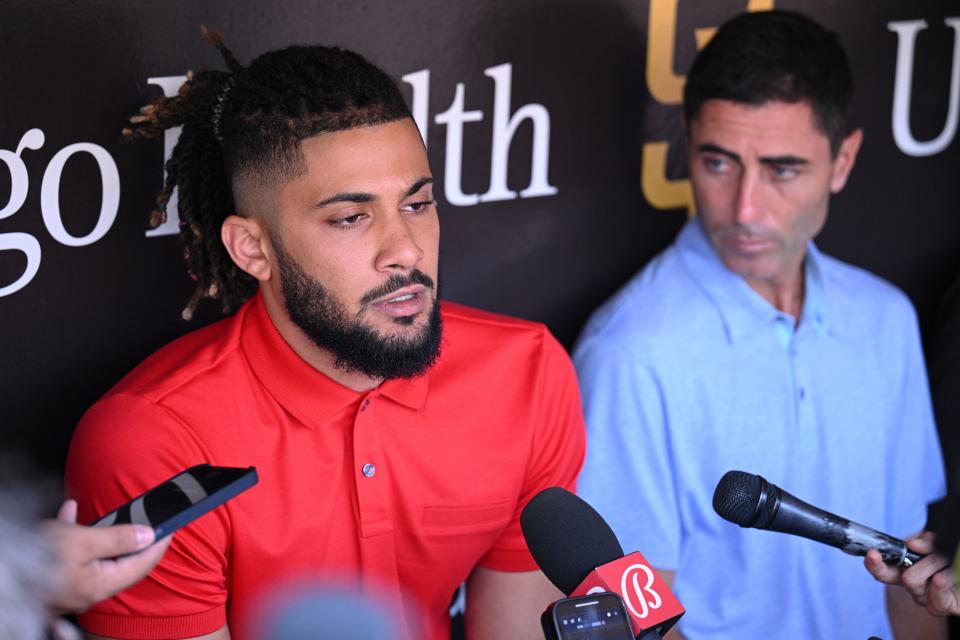 Fernando Tatis Jr., with GM A.J. Preller, speaks to the media on Aug. 23 at Petco Park in San Diego.