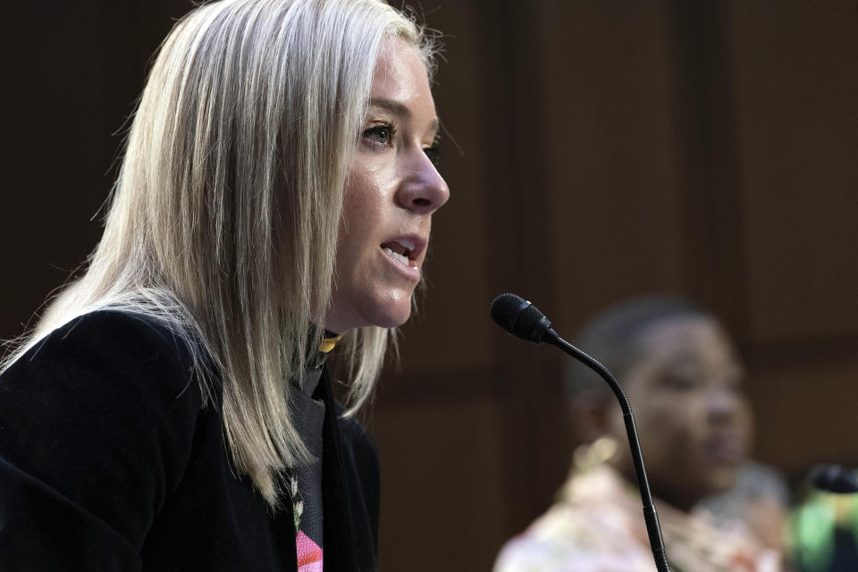 Amanda Zurawski speaks into a microphone at a Senate hearing.