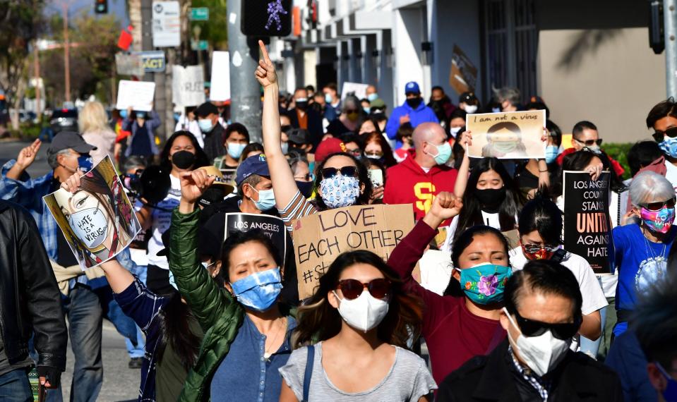 Social activists hold signs as they march from San Gabriel City Hall to Alhambra City Hall in California on March 26, 2021, during an anti-Asian hate rally. - The protesters were joined by leaders from the respective cities in the San Gabriel Valley, home to one of the largest Asian American communities in the United States. (Photo by Frederic J. BROWN / AFP) (Photo by FREDERIC J. BROWN/AFP via Getty Images) ORG XMIT: 0 ORIG FILE ID: AFP_96U939.jpg