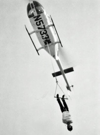 David Fee dangling from a helicopter over Oak Ridge’s Downtown Shopping Center parking lot while escaping from a straitjacket.