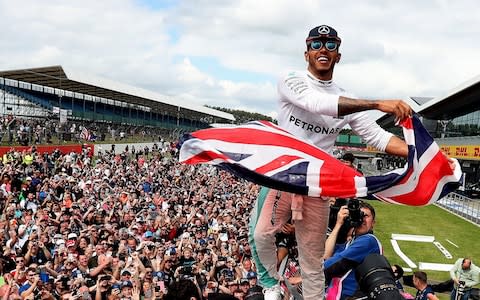 Lewis Hamilton celebrates his victory with the crowd after winning the 2016 British Grand Prix at Silverstone Circuit, Towcester. PRESS ASSOCIATION Photo. Issue date: Wednesday July 10, 2019. Home advantage should pay dividends for Hamilton, who won four in a row until last year when he was punted off early on the first lap by Kimi Raikkonen, then with Ferrari, but brilliantly fought from the back to claim second behind Sebastian Vettel - Credit: PA