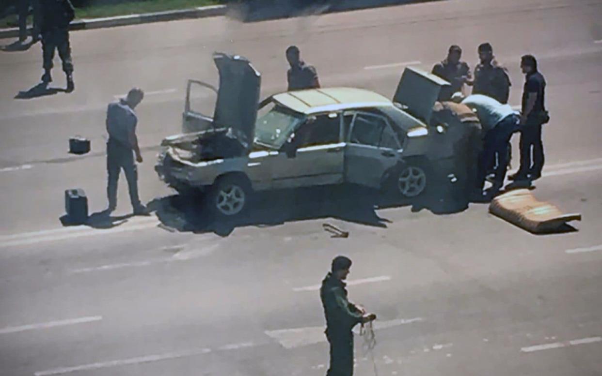 A Mercedes car without number plates tried to break through the police headquarters in Grozny - AFP