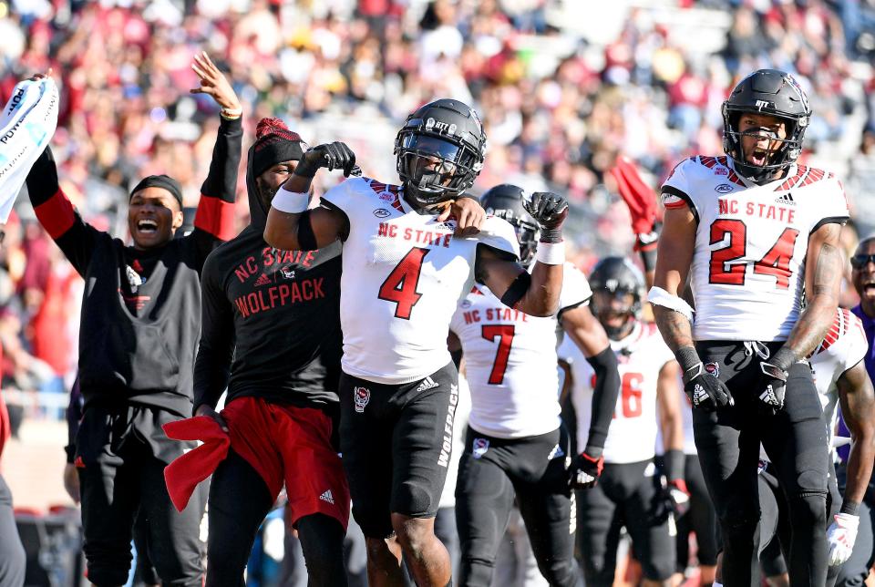 Nov 6, 2021; Tallahassee, Florida, USA; North Carolina State Wolfpack players celebrate with cornerback Cecil Powell (4) after his interception during the first quarter against the Florida State Seminoles at Doak S. Campbell Stadium. Mandatory Credit: Melina Myers-USA TODAY Sports