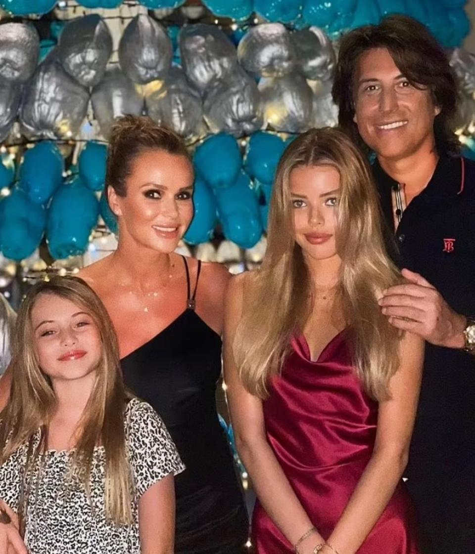 The TV star pictured with husband Chris Hughes and daughters Hollie (L) and Lexi (R) (Instagram/AmandaHolden)