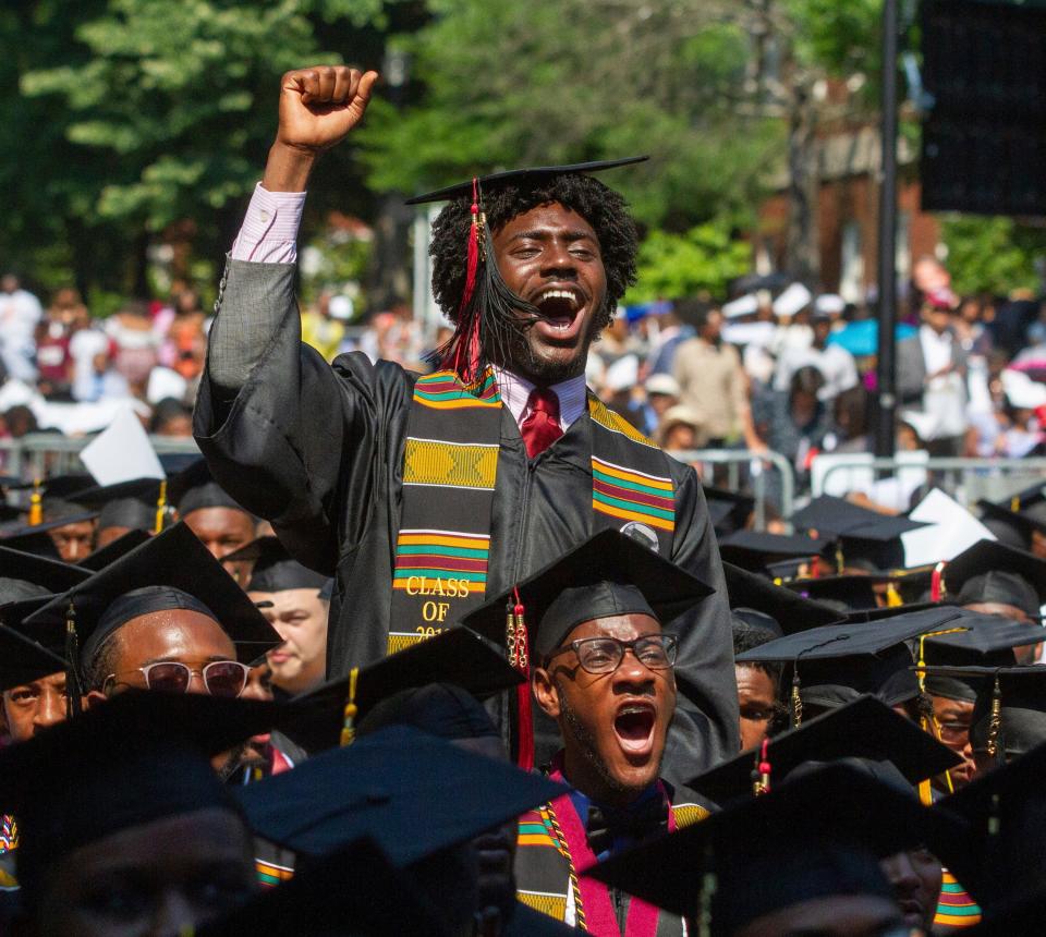 Graduates react after hearing billionaire technology investor and philanthropist Robert F. Smith say he will provide grants to wipe out the student debt of the entire 2019 graduating class at Morehouse College in Atlanta, Sunday, May 19, 2019.