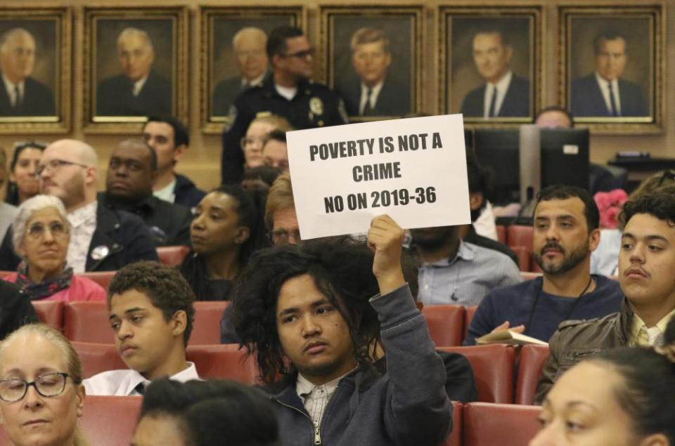 Rudolf Jovero of Las Vegas holds a sign inside council chambers during a protest against the city council’s ban in November.