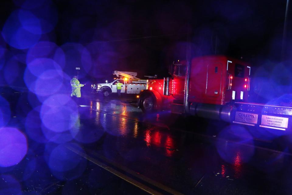 Sheriffs in Elgin manage traffic while power lines are down after several tornadoes touched down across Central Texas Monday, March 21, 2022.