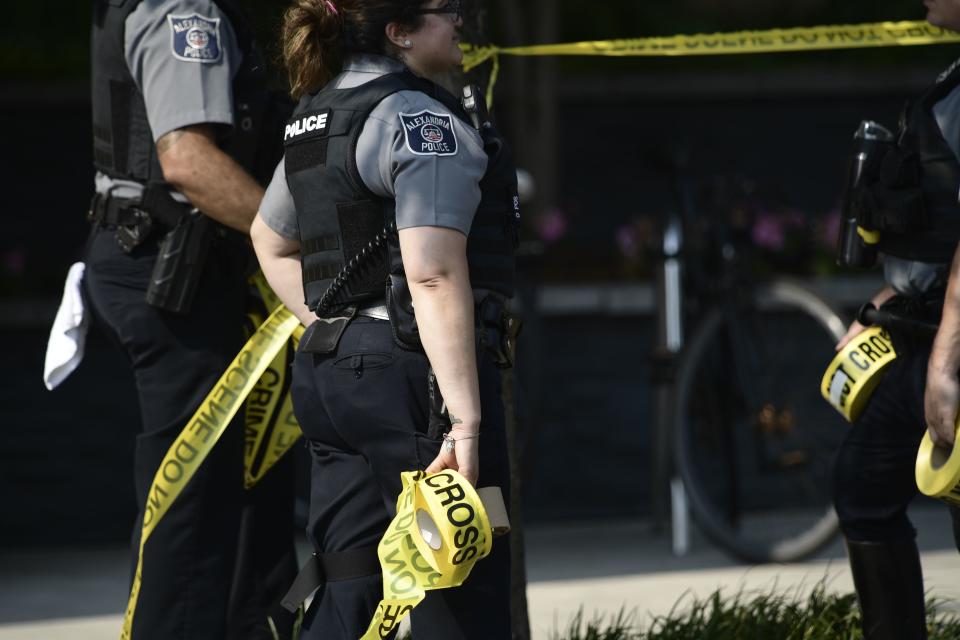 Alexandria police gather near the crime scene.