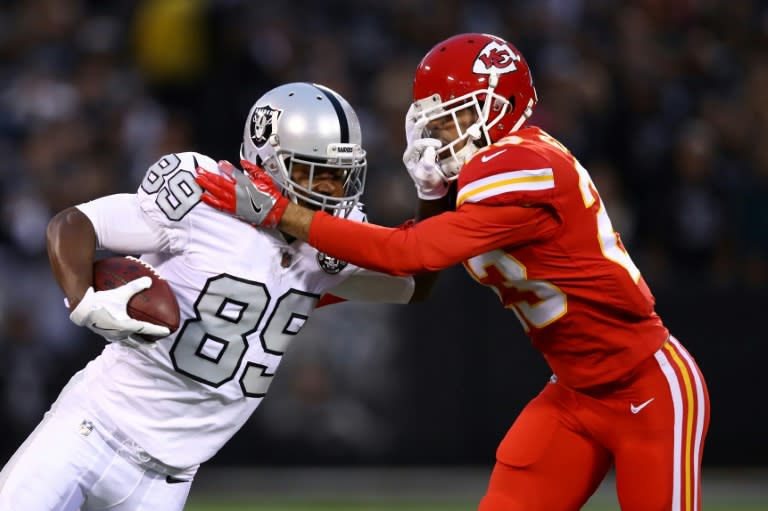 Amari Cooper (L) of the Oakland Raiders is pushed out of bounds by Phillip Gaines of the Kansas City Chiefs during their NFL game at Oakland-Alameda County Coliseum in Oakland, California, on October 19, 2017