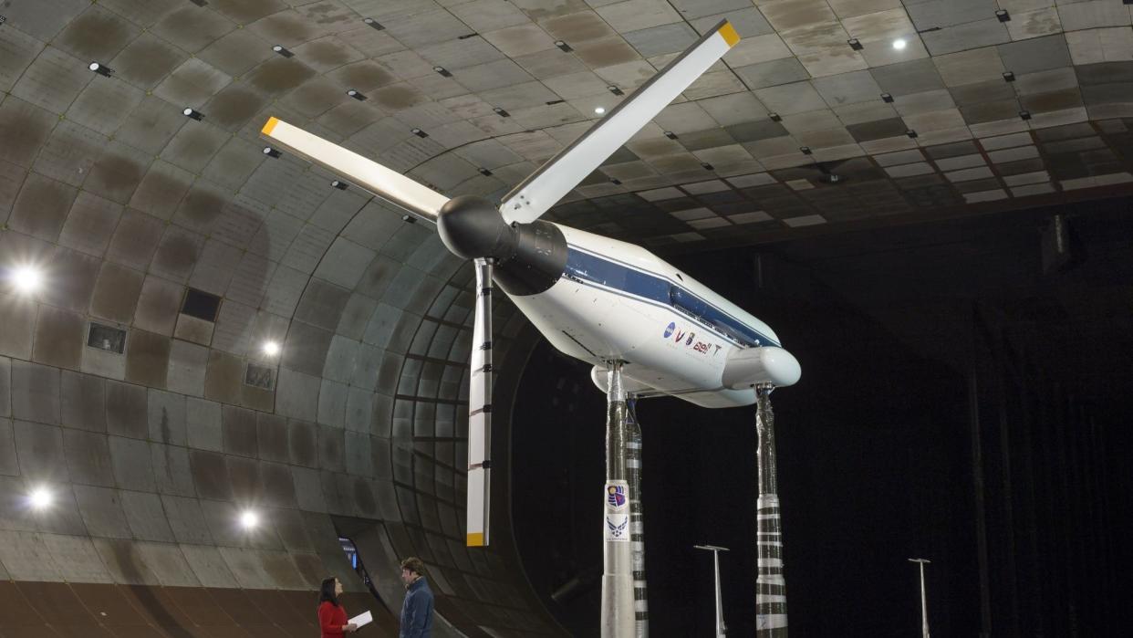 A rotor in the middle of a large wind tunnel.