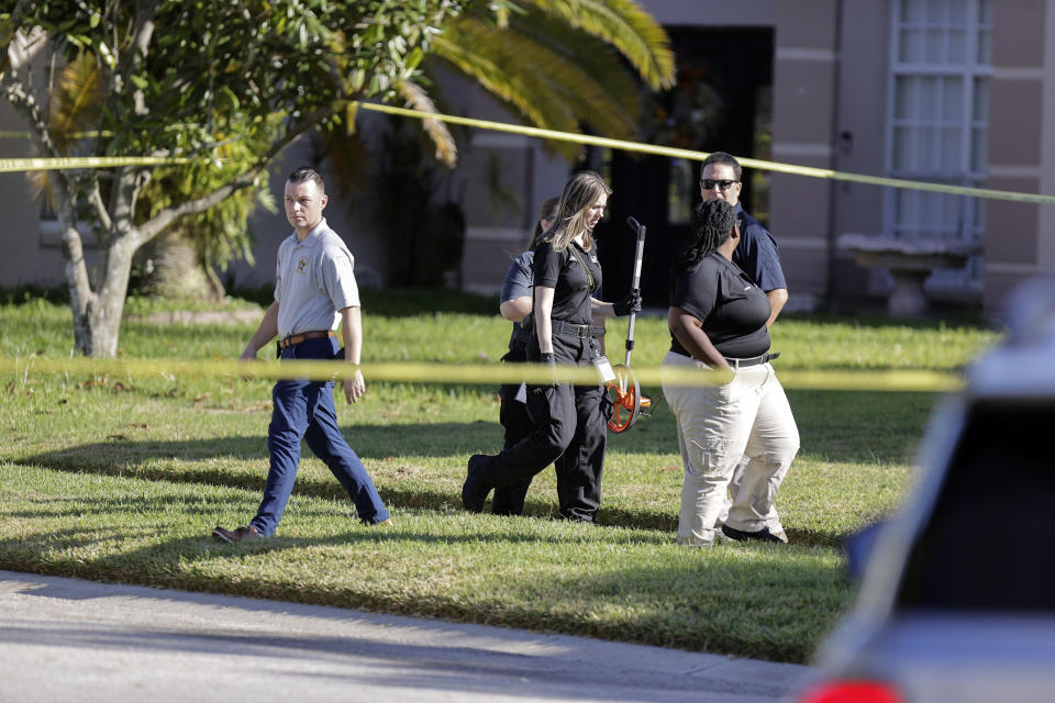 Hillsborough County Sheriff investigators on the scene of an incident where two of their own deputies were struck by a vehicle while on a call for service on Thursday, Nov. 9, 2023, in Brandon, Fla. The Hillsborough County deputies were answering a call from a woman who said her adult son was acting irrationally and she was afraid of him, Sheriff Chad Chronister said at a news conference. (Luis Santana/Tampa Bay Times via AP)