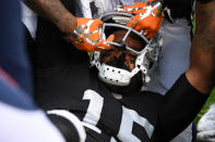 <p>Michael Crabtree #15 of the Oakland Raiders has his helmet pulled off during a fight with Aqib Talib #21 of the Denver Broncos in their NFL game at Oakland-Alameda County Coliseum on November 26, 2017 in Oakland, California. Both players were ejected from the game. (Photo by Robert Reiners/Getty Images) </p>