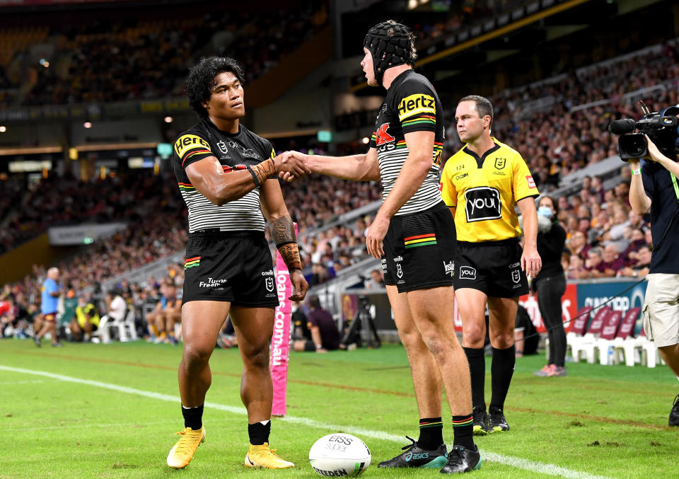 Matt Burton shakes hands with team mate Brian To'o after a Penrith try.