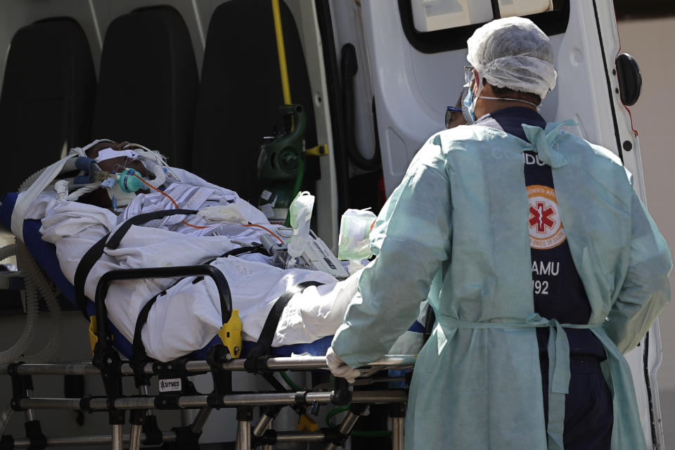 A patient suspected of having COVID-19 is received at the HRAN Hospital in Brasilia, Brazil, Wednesday, March 3, 2021. The number of new COVID-19 cases in Brazil is still surging, with a new record high of deaths reported on Tuesday. (AP Photo/Eraldo Peres)