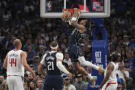 Dallas Mavericks forward P.J. Washington dunks the ball as Los Angeles Clippers center Mason Plumlee (44), Mavericks' center Daniel Gafford (21) and Clippers' guard James Harden look on during the first half of Game 4 of an NBA basketball first-round playoff series Sunday, April 28, 2024, in Dallas. (AP Photo/Jeffrey McWhorter)