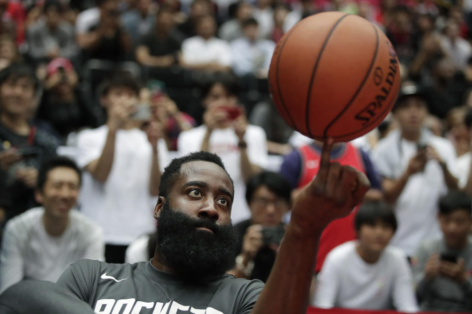 Houston Rockets' James Harden spins the ball during warmups for the team's NBA preseason basketball game against the Toronto Raptors Thursday, Oct. 10, 2019, in Saitama, near Tokyo. (AP Photo/Jae C. Hong)