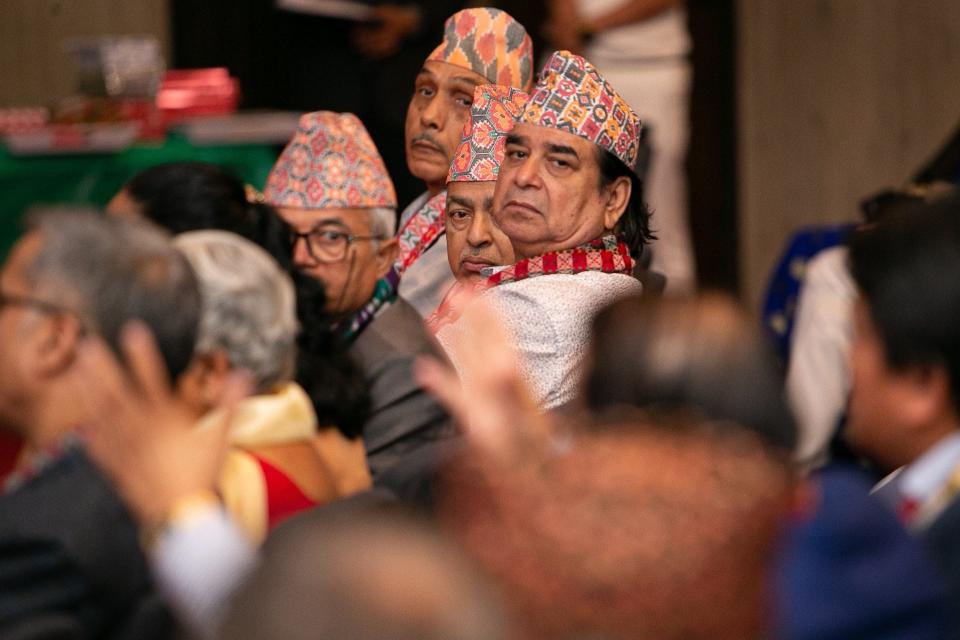 Nepali-Bhutanese diasporic men listen to another community member’s question June 25 during an international literary convention hosted by the Literature Council of Bhutan at the Ohio History Center in Columbus.