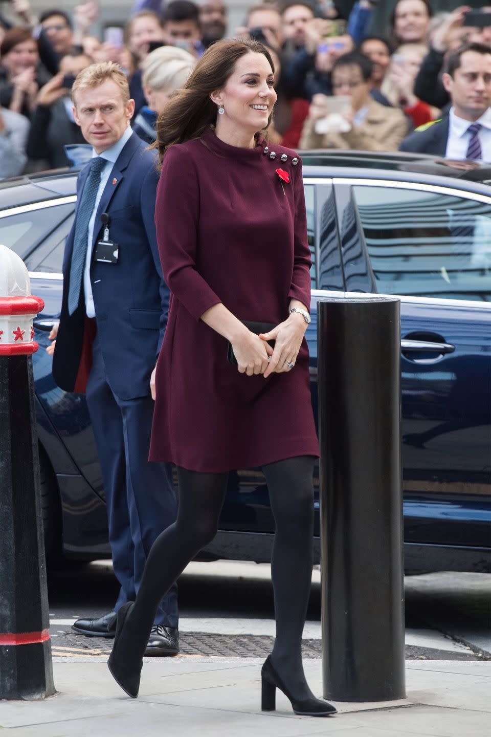 <p>In a plum mod dress with silver button accents by Goat, black tights, and black suede pumps at the annual Place2Be School Leaders Forum in London.</p>