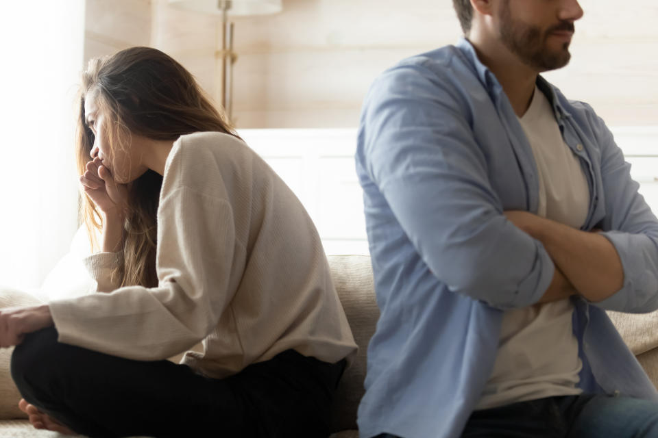 Stressed young married couple sitting separately on different sides of sofa, ignoring each other after quarrel. Offended spouses do not talk communicate, feeling depressed disappointed after argue. - Copyright: getty images