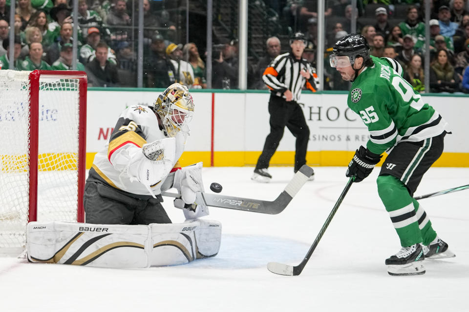 Vegas Golden Knights goaltender Logan Thompson, left, makes a save as Dallas Stars center Matt Duchene attacks during the first period of an NHL hockey game, Saturday, Dec. 9, 2023, in Dallas. (AP Photo/Julio Cortez)