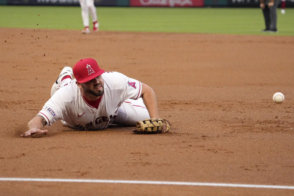 Los Angeles Angels first baseman Mike Moustakas can't get to a ball hit for a single by Cleveland Guardians' Andres Gimenez during the second inning of a baseball game Saturday, Sept. 9, 2023, in Anaheim, Calif. (AP Photo/Mark J. Terrill)