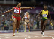 United States' Carmelita Jeter reacts as she crosses the finish line to win the women's 4 x 100-meter relay during the athletics in the Olympic Stadium at the 2012 Summer Olympics, London, Friday, Aug. 10, 2012. The United States relay team set a new world record with a time of 40.82 seconds.(AP Photo/Anja Niedringhaus)