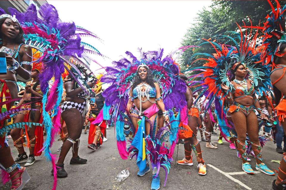 Dancers wear colourful costumes during last year's carnival PA)