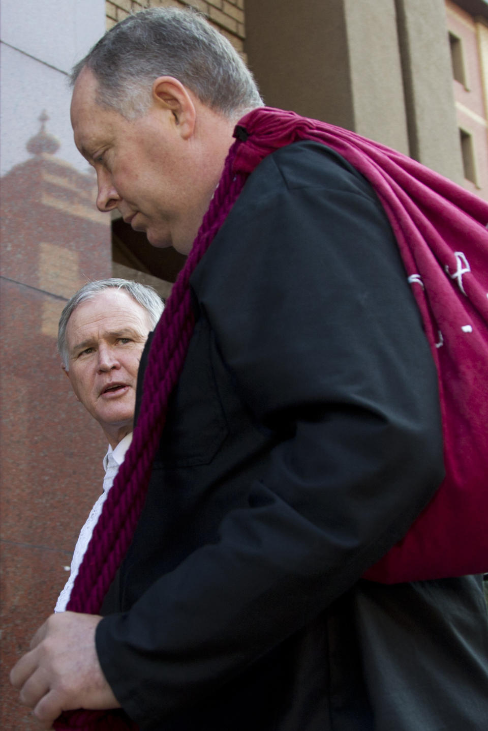 Barry Roux, left, and Kenny Oldwage, the lawyers defending Oscar Pistorius, arrive at the high court in Pretoria, South Africa, Tuesday, March 18, 2014. Pistorius is charged with murder for the shooting death of his girlfriend, Reeva Steenkamp, on Valentines Day in 2013. (AP Photo/Themba Hadebe)