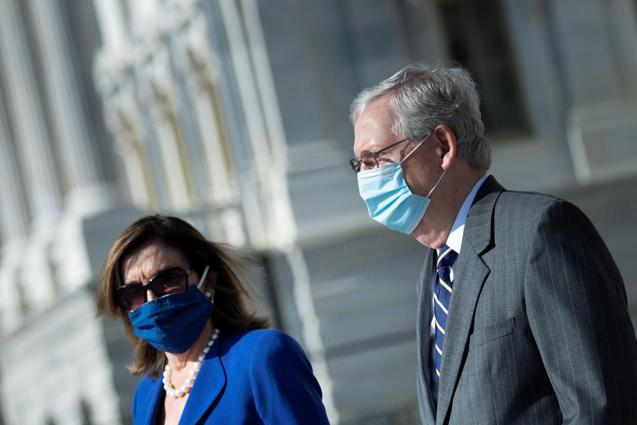 Speaker of the House Nancy Pelosi (D-CA) and Senate Majority Leader Mitch McConnell (R-KY) arrive to watch the casket with the remains of Rep. John Lewis (D-GA) being carried from the U.S. Capitol building, in Washington, U.S., July 29, 2020. Brendan Smialowski/Pool via REUTERS