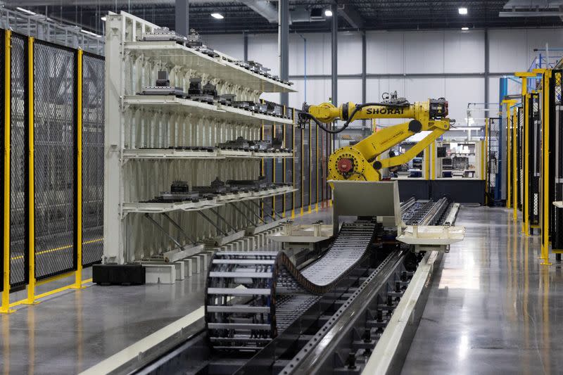 FILE PHOTO: The robot arm of an automated five-axis cell used in the production and manufacturing of aircraft parts operates autonomously at Abipa Canada in Boisbriand