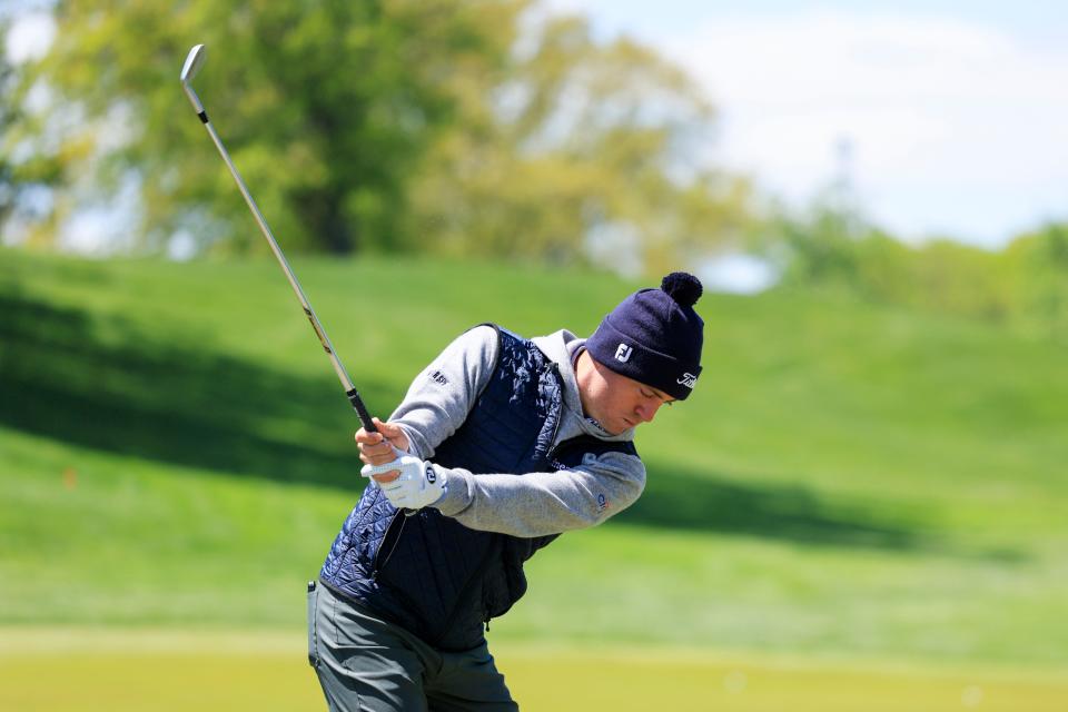 Defending PGA champion Justin Thomas hits on the Oak Hill driving range during Wednesday's chilly conditions.