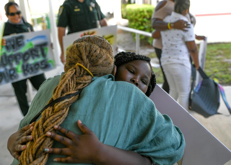 Fourth-grade student Zamoney Sanders, 9, shares a hug with kindergarten teacher Sylvia Grier while going through the Tunnel of Hope during the opening day of school at Chester A. Moore Elementary School on Wednesday, Aug. 10, 2022, in Fort Pierce. "Cool, because I love my teachers," Zamoney said