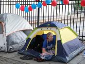 A supporter of U.S. President Donald Trump sits in a tent near the BOK Center in Tulsa