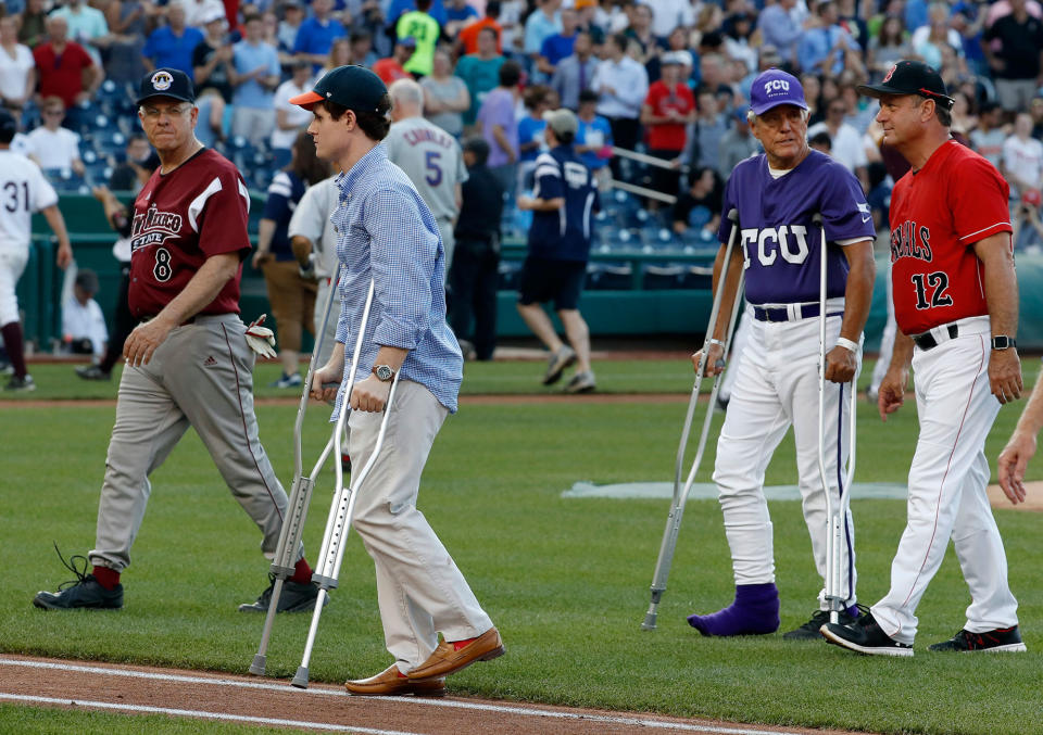 <p>Injured aide Zach Barth, left, and Rep. Roger Williams, R-Texas, also on crutches walk off the field before the Congressional baseball game, Thursday, June 15, 2017, in Washington. (Photo: Alex Brandon/AP) </p>